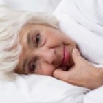 Elderly lady lying in bed