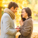 Young couple getting engaged in autumnal scene