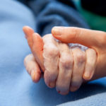 Holding elderly hand