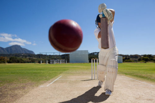 Cricket batsman hitting ball