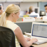 Female office worker on laptop