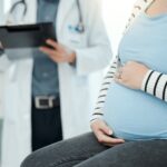 Pregnant woman with doctor.